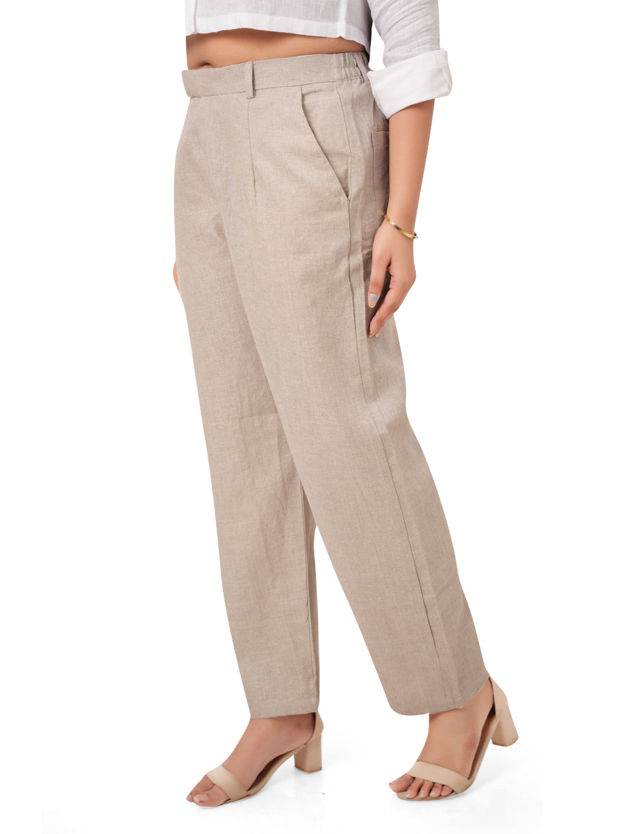 Beige linen pants worn by a person on a white background right view
