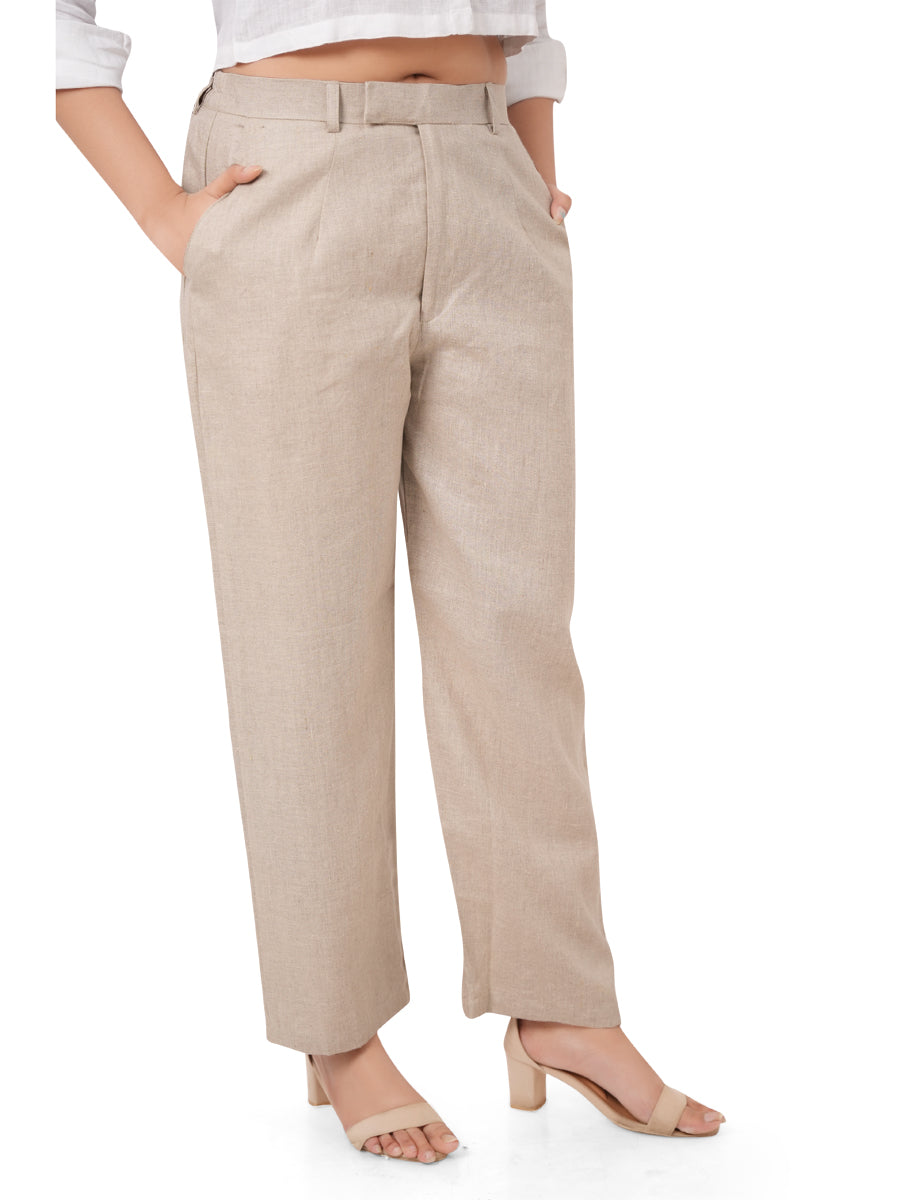 Beige linen pants worn by a person on a white background, side view