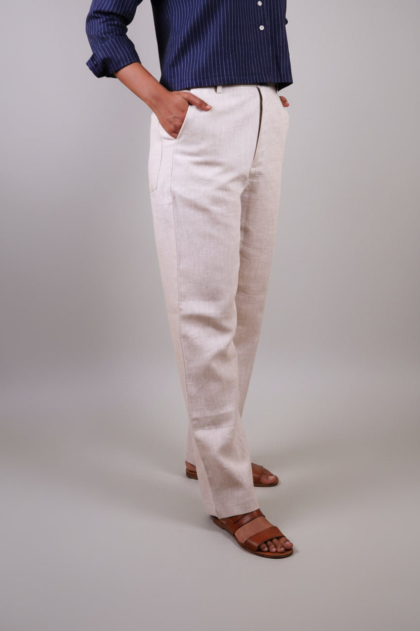Person wearing beige linen pants by sabr india and a blue top 