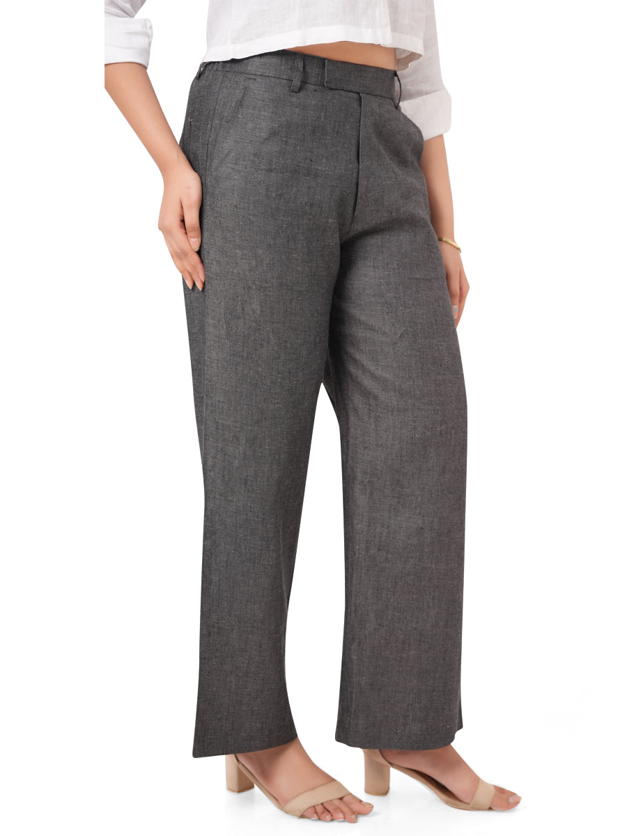 charcoal black linen pants worn by a person on a white background, side view